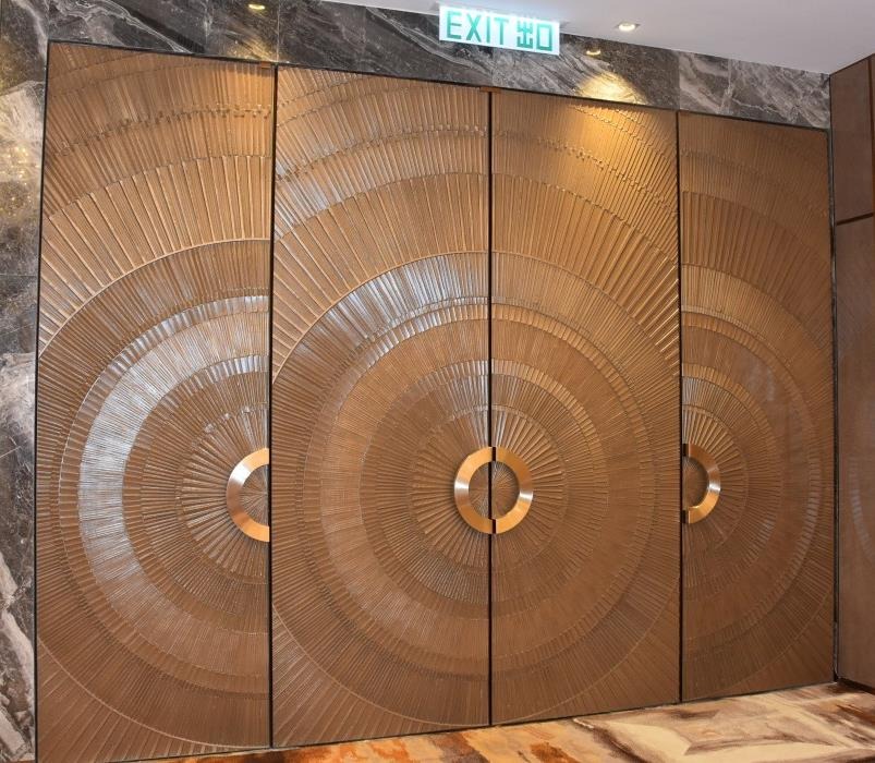 Architectural door featuring a circular textured surface